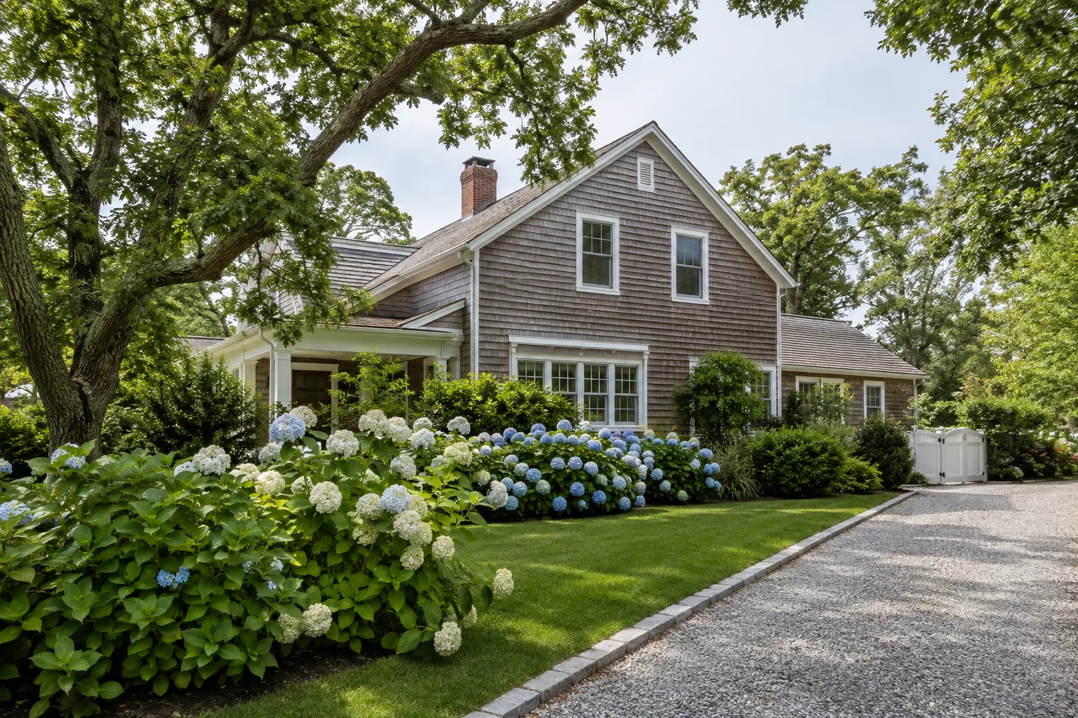 Cedar home with hydrangeas, native landscaping and a gravel driveway